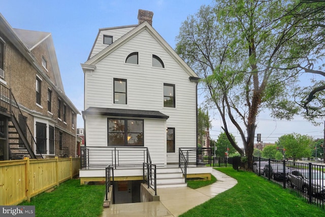 rear view of house with a yard