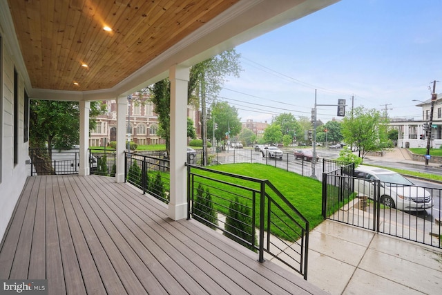 wooden terrace featuring a lawn