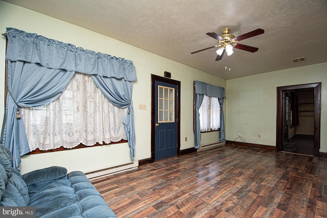 foyer featuring ceiling fan, dark hardwood / wood-style flooring, and a textured ceiling