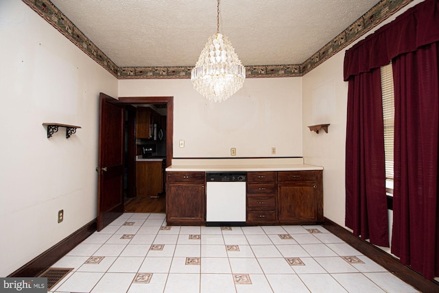 kitchen with dishwasher, decorative light fixtures, a notable chandelier, a textured ceiling, and light tile floors