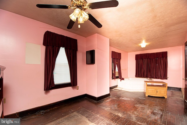 spare room featuring a textured ceiling and ceiling fan