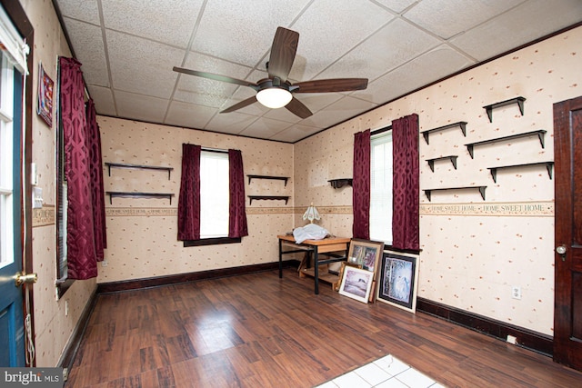 unfurnished room featuring ceiling fan, hardwood / wood-style floors, and a paneled ceiling