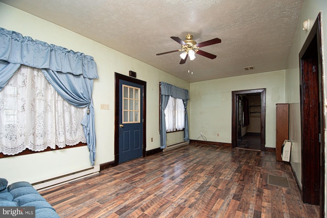 foyer featuring wood-type flooring, a baseboard radiator, ceiling fan, and a textured ceiling