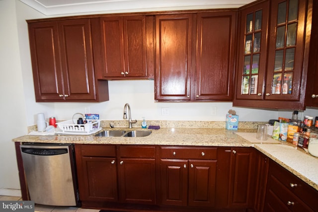 kitchen with sink, light stone countertops, and stainless steel dishwasher