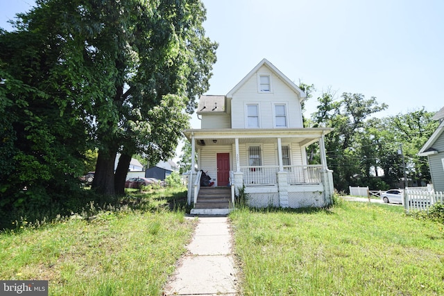 view of front facade with a front yard and covered porch