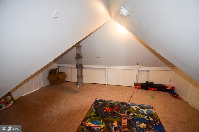 interior space featuring lofted ceiling and carpet