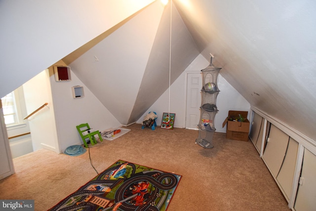 playroom with light colored carpet and lofted ceiling