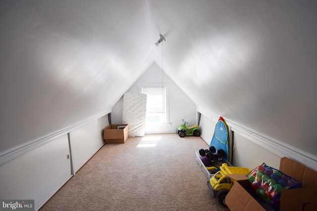 game room with vaulted ceiling and carpet flooring