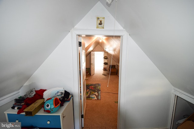 interior space featuring vaulted ceiling and carpet flooring