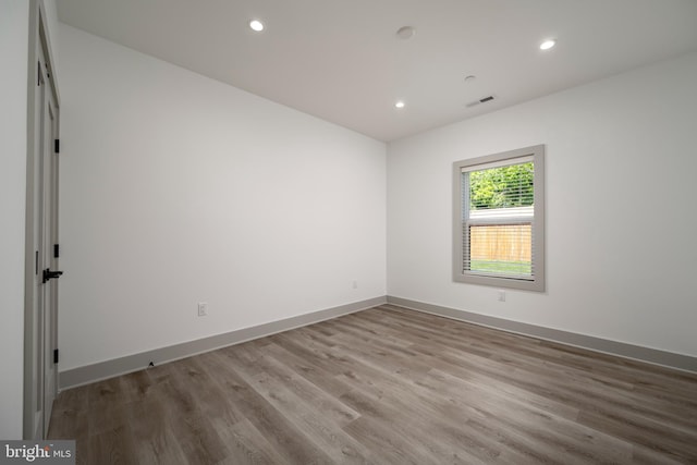 spare room with wood-type flooring