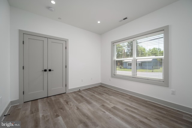 unfurnished bedroom with wood-type flooring