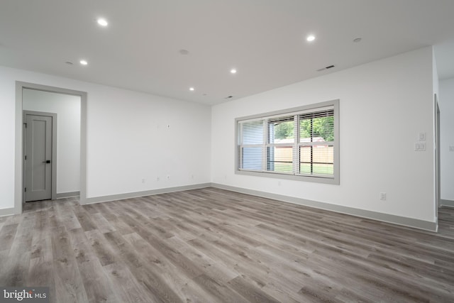 spare room with hardwood / wood-style floors