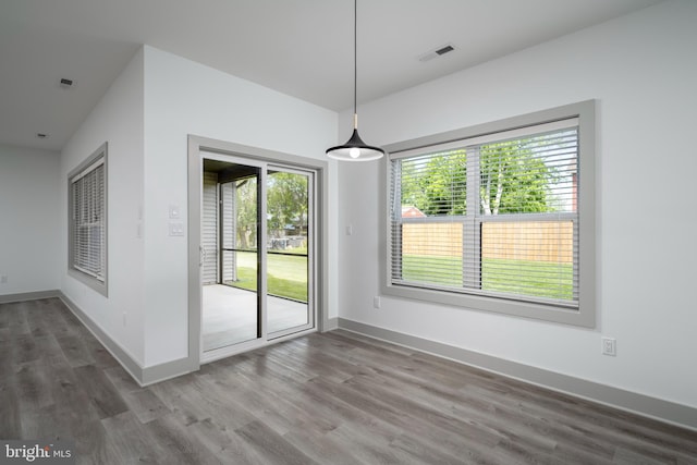 unfurnished dining area with wood-type flooring