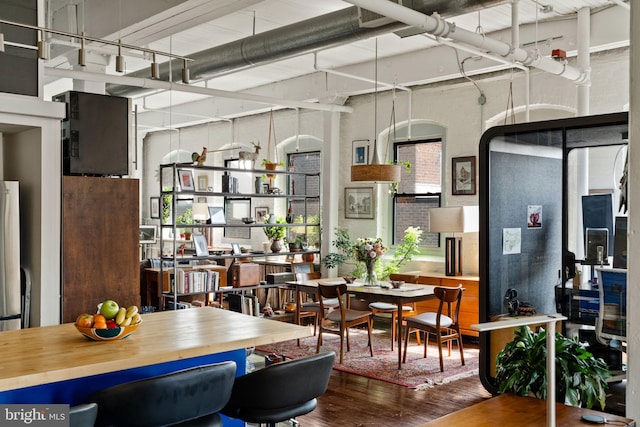 dining space with wood-type flooring