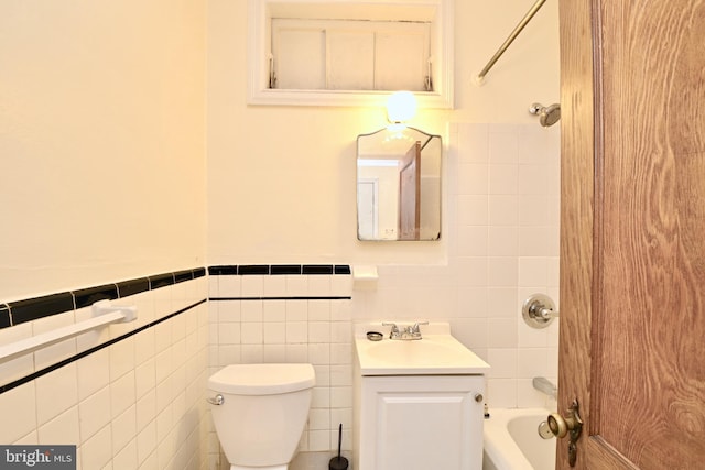 full bathroom with large vanity, tile walls, toilet, and tub / shower combination