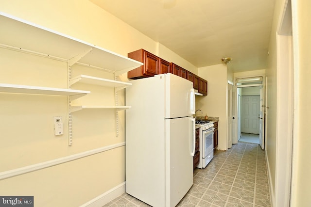 kitchen with white appliances and light tile floors