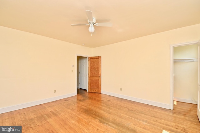 unfurnished bedroom with ceiling fan, a closet, and light wood-type flooring