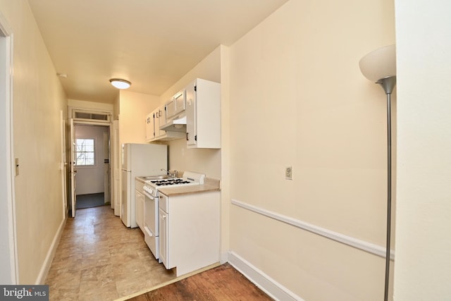 kitchen featuring light hardwood / wood-style floors, white gas range oven, and white cabinets