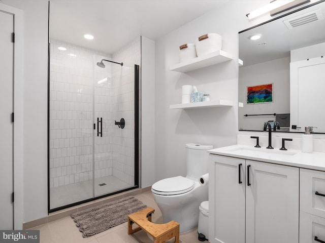 bathroom with tile patterned floors, vanity, toilet, and an enclosed shower