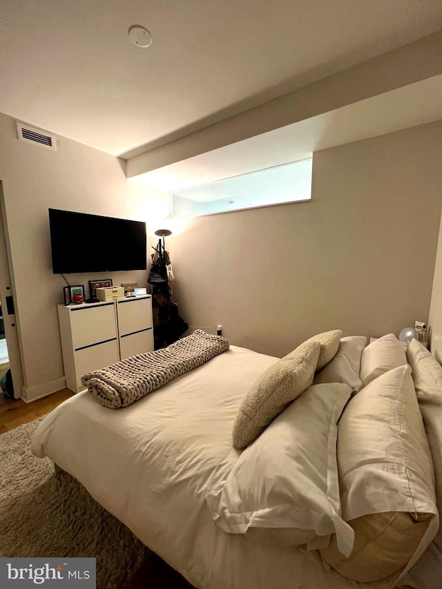 bedroom with hardwood / wood-style floors