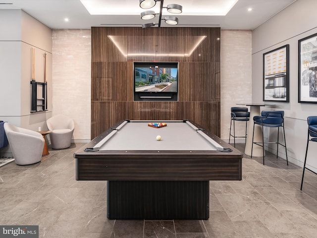 game room with wood walls, tile walls, and pool table