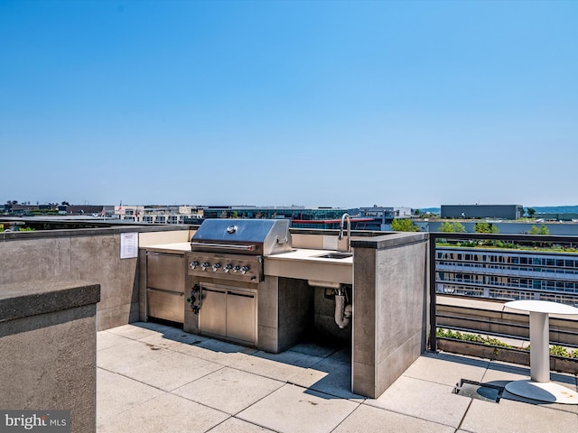 view of patio / terrace featuring sink, exterior kitchen, and a grill