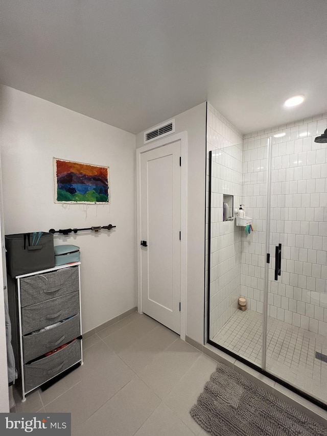 bathroom with tile patterned flooring and an enclosed shower