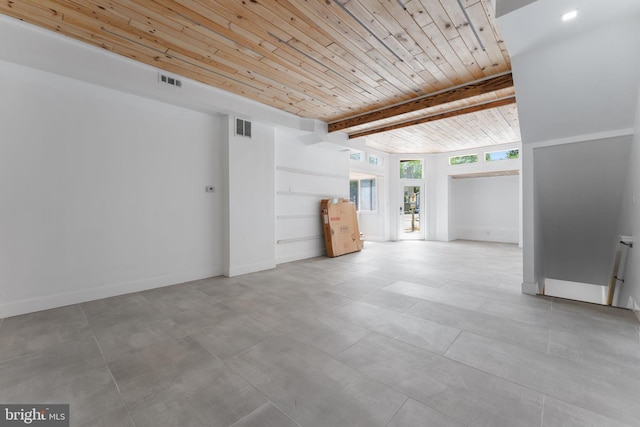 unfurnished living room featuring beamed ceiling, wooden ceiling, and light tile flooring