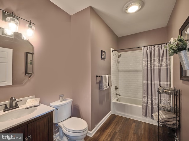 full bathroom featuring shower / bathtub combination with curtain, hardwood / wood-style floors, toilet, and vanity