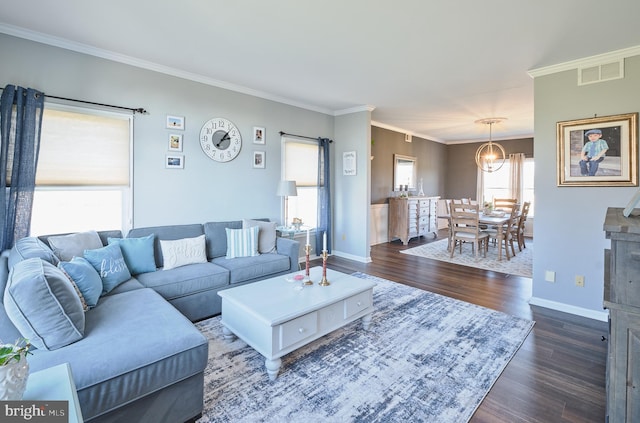 living room featuring a wealth of natural light, dark wood-type flooring, and crown molding