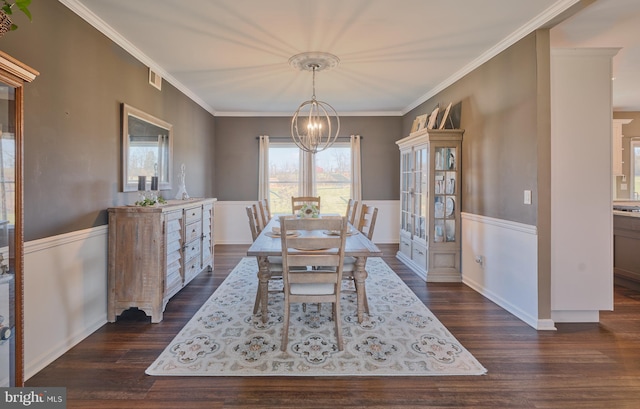 dining space with a notable chandelier, ornamental molding, and dark hardwood / wood-style floors