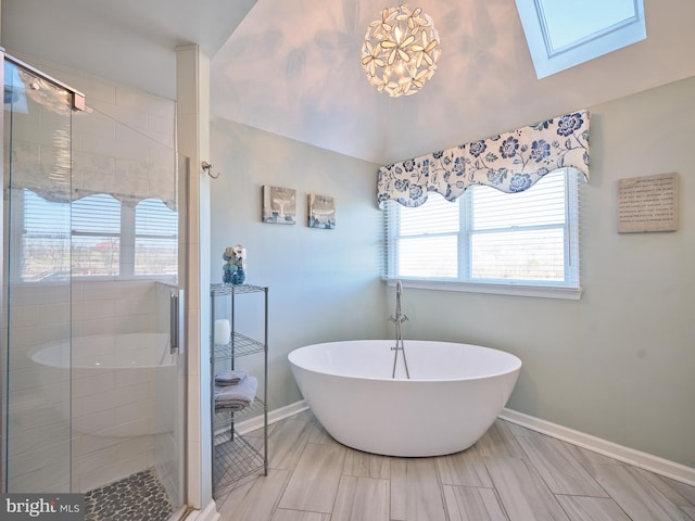 bathroom featuring tile flooring, independent shower and bath, and a skylight