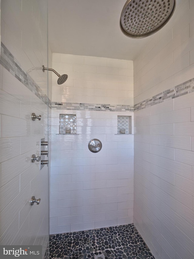 bathroom with a tile shower