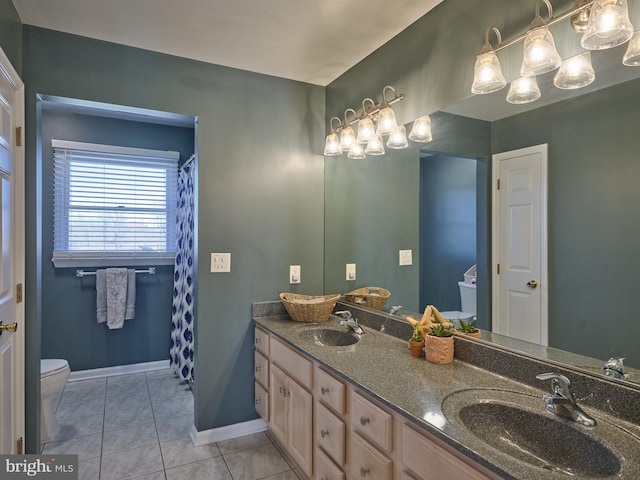 bathroom with tile flooring, dual vanity, and toilet