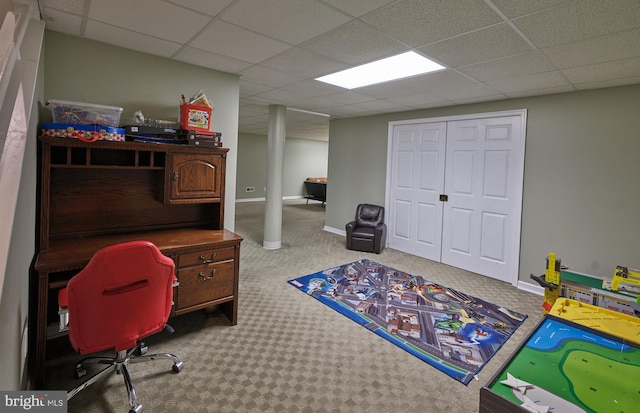 interior space featuring carpet floors and a paneled ceiling