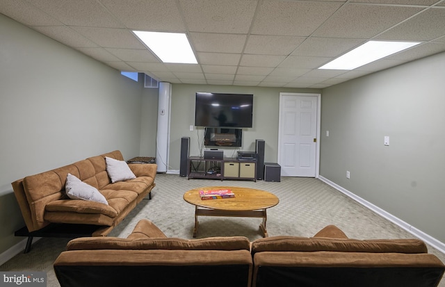 living room featuring a paneled ceiling and carpet