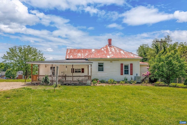 back of property with a porch and a lawn