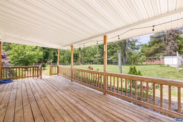 wooden deck featuring a lawn