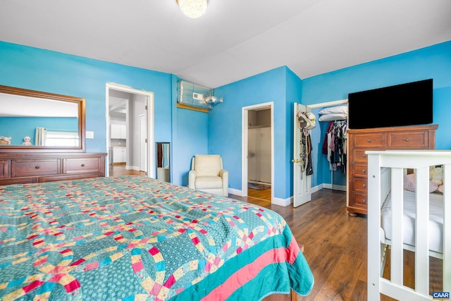 bedroom with dark wood-type flooring and a closet