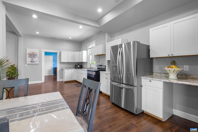 kitchen featuring dark hardwood / wood-style floors, light stone countertops, stainless steel appliances, sink, and white cabinetry