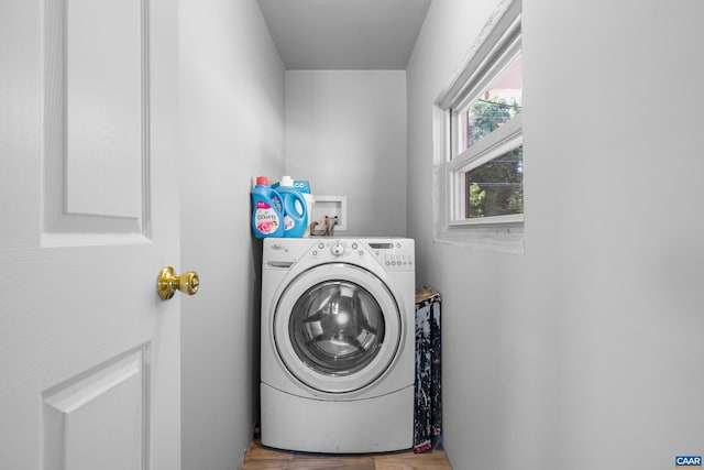 clothes washing area featuring washer / dryer and wood-type flooring