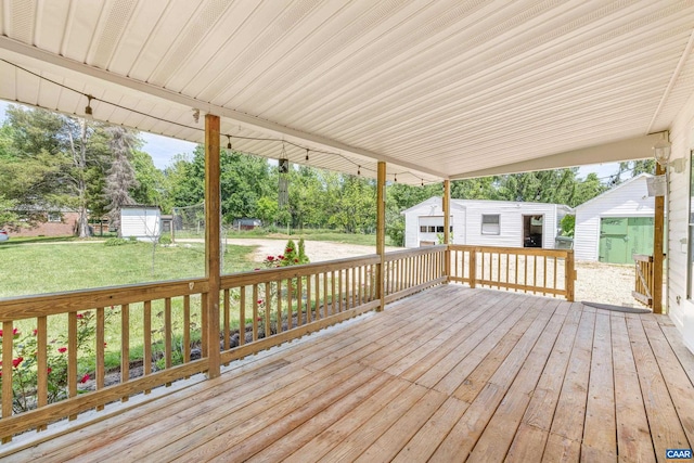 deck featuring a shed and a lawn