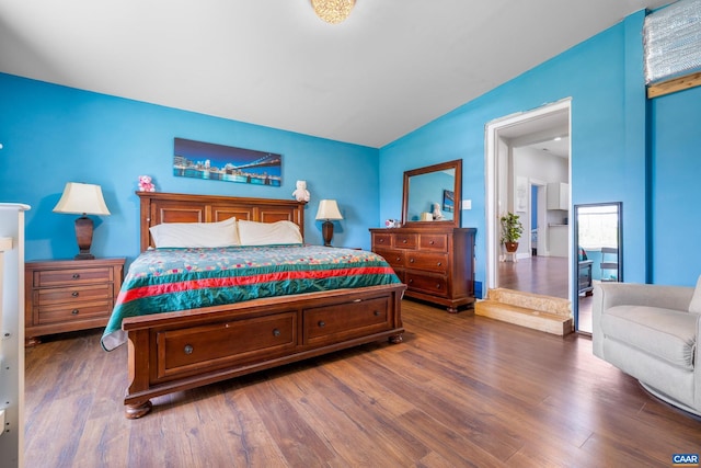 bedroom featuring dark hardwood / wood-style flooring and lofted ceiling