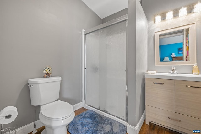 bathroom featuring an enclosed shower, oversized vanity, toilet, and wood-type flooring