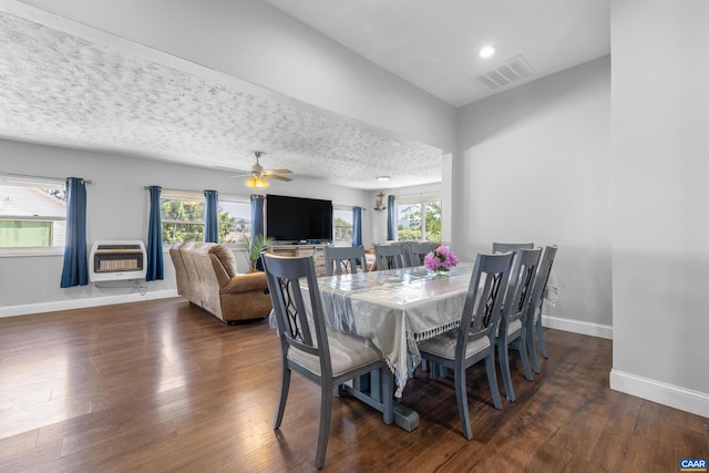 dining area featuring an AC wall unit, a textured ceiling, ceiling fan, and dark hardwood / wood-style flooring