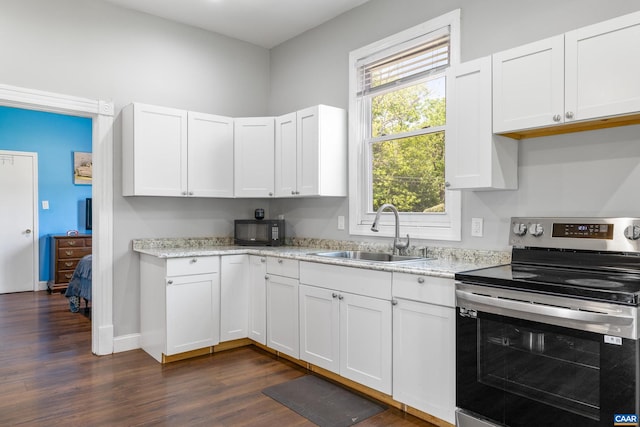 kitchen with white cabinets, sink, dark hardwood / wood-style flooring, and stainless steel range with electric cooktop