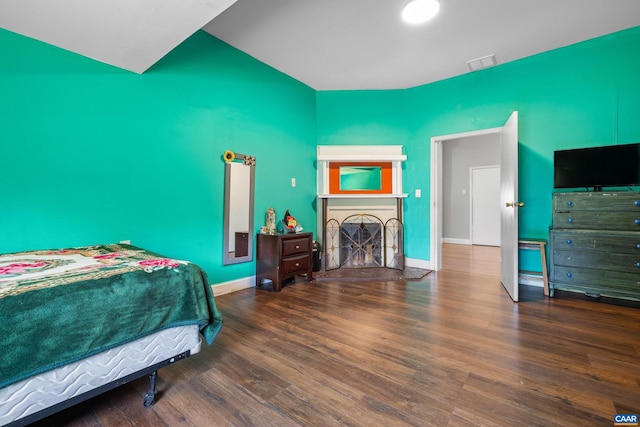 bedroom with dark hardwood / wood-style flooring