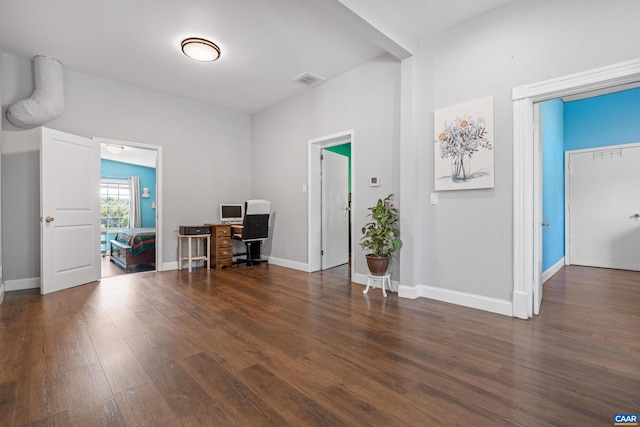 unfurnished office with dark hardwood / wood-style flooring