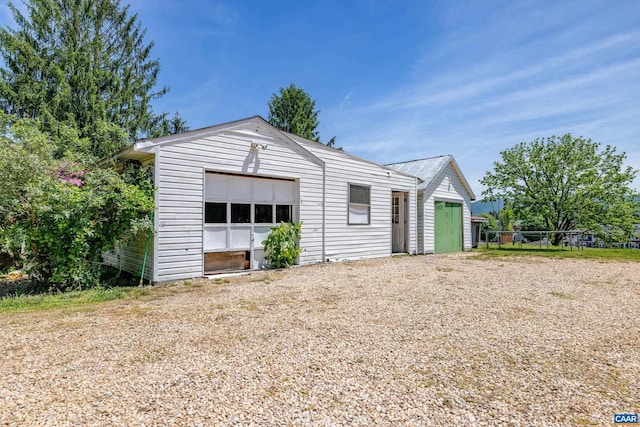 view of front of property featuring an outdoor structure and a garage