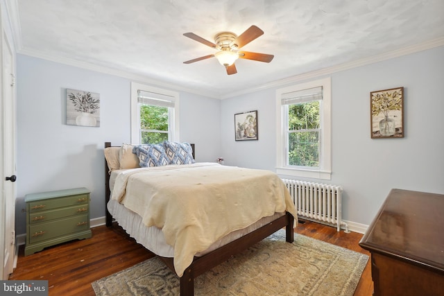 bedroom with radiator heating unit, dark hardwood / wood-style floors, ceiling fan, and crown molding